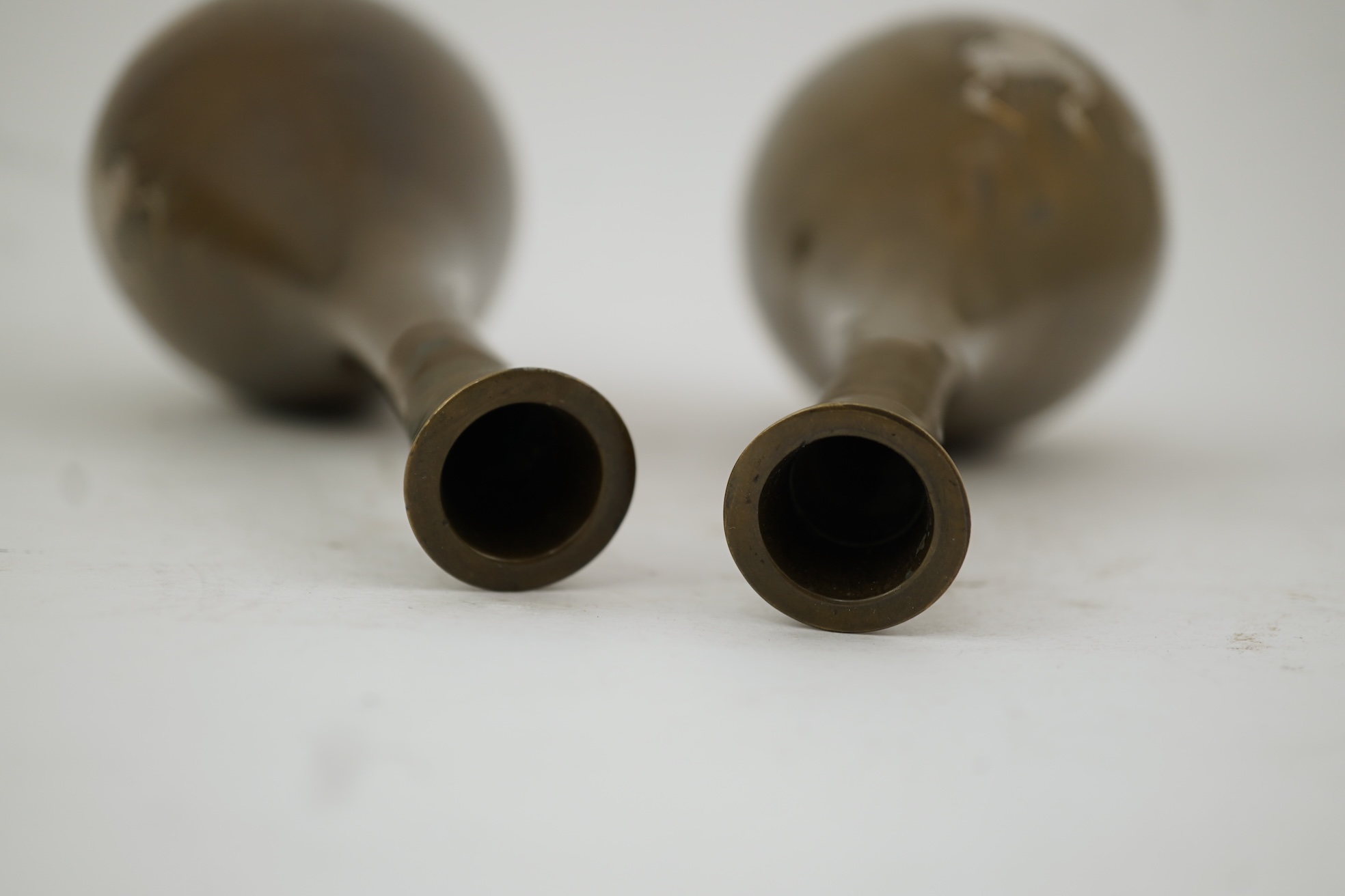 A pair of Japanese bronze and mixed metal inlaid bottle vases, signed Hidemitsu, Meiji period